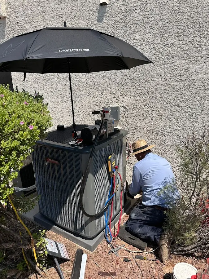HVAC technician performing outdoor AC maintenance in Glendale